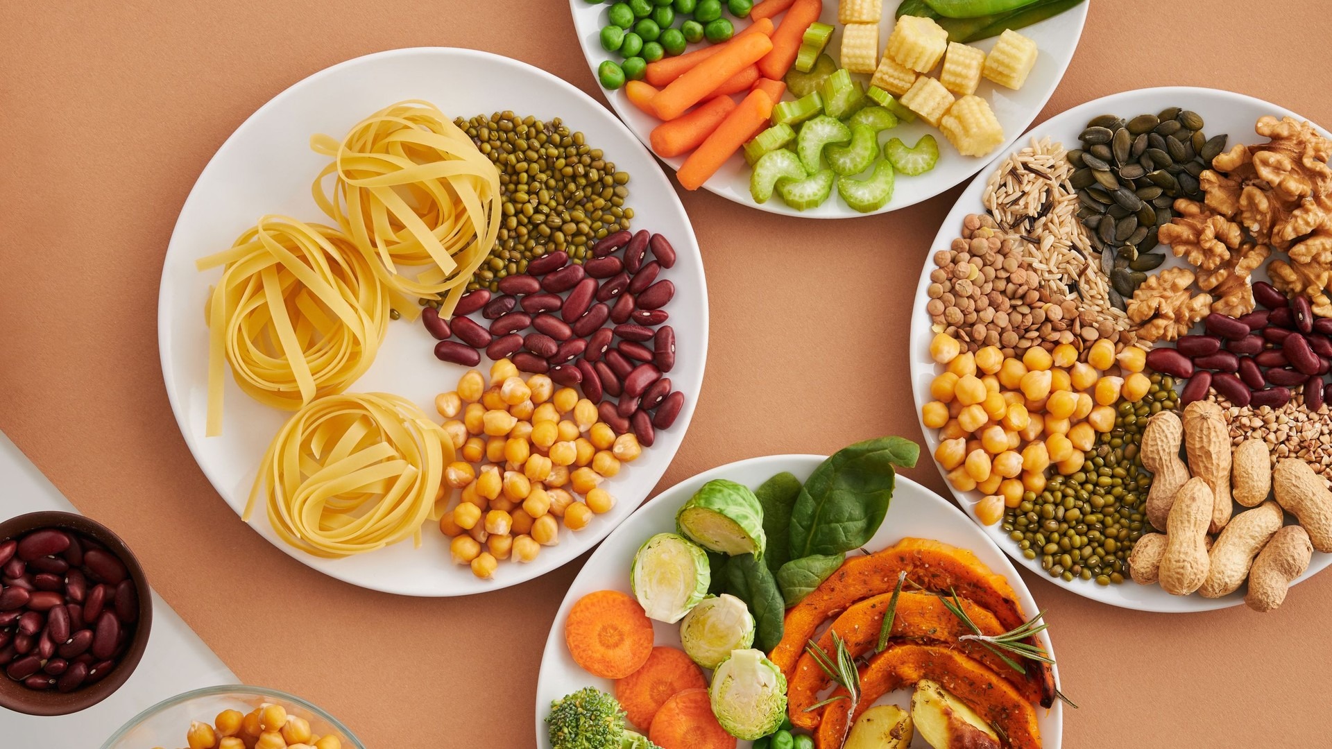Plates of fiber-rich foods: beans, chickpeas, lentils, peas, vegetables, nuts and seeds